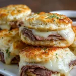 Easy baked French dip biscuits arranged on a plate, served with dipping sauce.