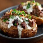Steak-Stuffed Baked Potatoes with Parmesan Cream Sauce